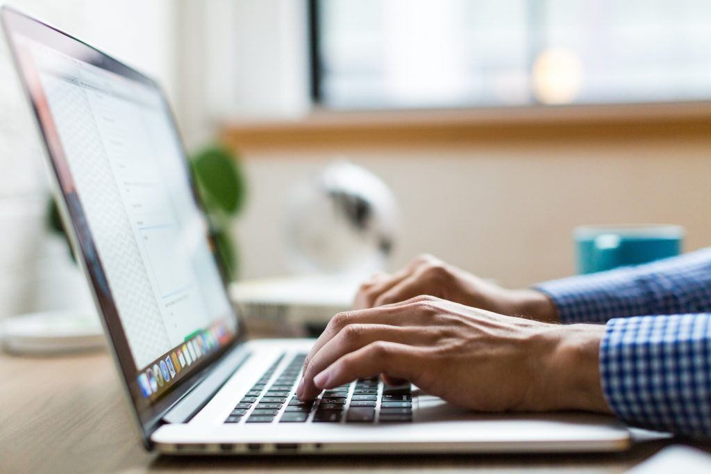 Person typing on computer for freight logistics